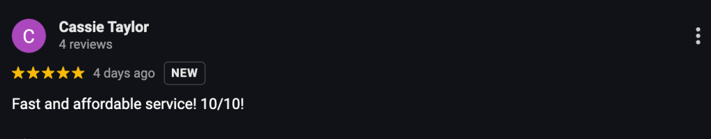 Workers tearing down a small shed and clearing debris.