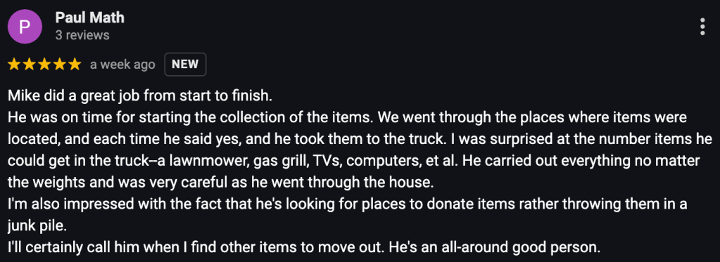 Cluttered garage being cleaned out with old furniture and boxes removed.